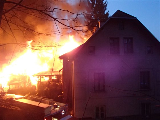 Požár zachvátil dřevěné objekty vedle rodinného domu v Trutnově.