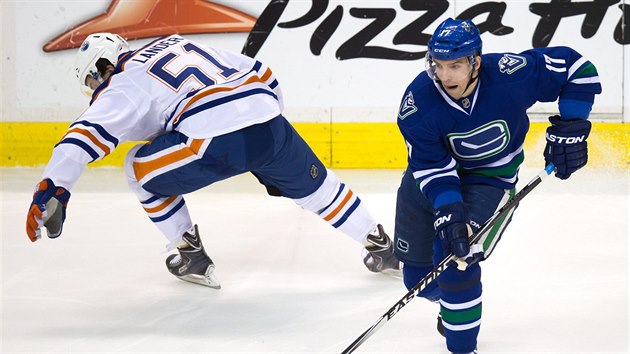 Radim Vrbata (vpravo) z Vancouveru obchz Antona Landera z Edmontonu.