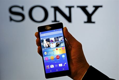 Employee poses with Sony's new Xperia Z4 smartphone after a news conference in...