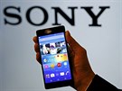 Employee poses with Sony's new Xperia Z4 smartphone after a news conference in...