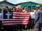 Lidé drí liberijskou vlajku bhem oslav konce epidemie v zemi (11. kvtna...