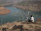 A villager sits on a hill overlooking part of Bhatsa dam on the outskirts of...