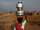 Sakhri, the second wife of Sakharam Bhagat carries a metal pitcher filled with...