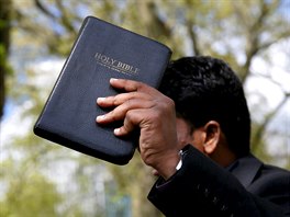 A Christian speaker holds a copy of the Bible at Speakers' Corner in Hyde...