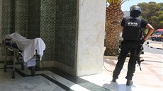 Policista stojí na stráži poblíž pláže, kde během pátku útočník zabil desítky...