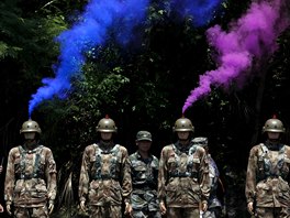 VÝROČÍ. Figuríny, jimž vychází z přileb barevný kouř, obklopují vojáci Čínské...