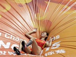 China's Li Ling lays on the mat after an attempt in women's pole...