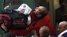 Jeden z uprchlík brání svj batoh a snaí se stejn jako stovky dalích...