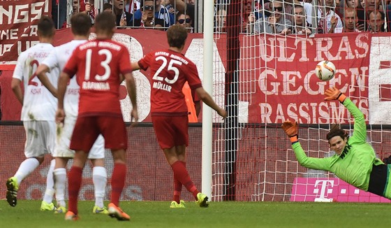 Thomas Müller z Bayernu Mnichov z penalty pekonává Marwina Hitze z Augsburgu.