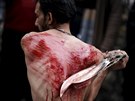 A Shi'ite Muslim living in Greece flagellates himself during a Muharram...