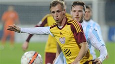 Tomáš Berger (v popředí) z Dukly kontroluje míč před Ivanem Šnircem z Ústí nad...