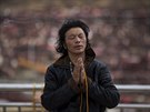 An ethnic Tibetan man prays at a monastery above the Larung Wuming Buddhist...