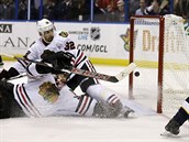 Obrnce Michal Rozsval (druh zleva) a glman Corey Crawford z Chicaga se...