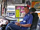 Plang Pansaior, a 66-year-old bus driver, waits for passengers while working...