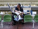 Pornsak Bowornsrisuk sits on a bench while managing at a bus terminal in...