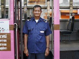 Plang Pansaior, a 66-year-old bus driver, poses for a portrait while working...