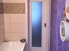 Koupelna po rekonstrukci - prosklené dveře propouštějí světlo do předsíně.