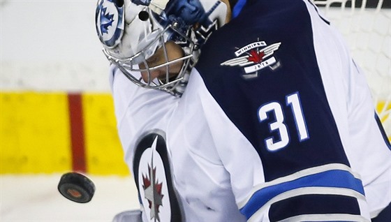 Brankář Winnipegu Ondřej Pavelec hypnotizuje letící puk.