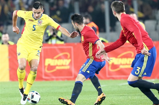 Rumunský fotbalista Ovidiu Stefan Hoban (vlevo) sledovaný panlským duem Mario...