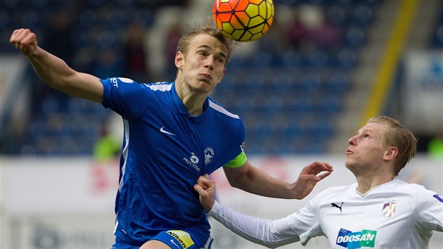 Libereck stoper Luk Pokorn (vlevo) si na hlav hld baln, situaci bedliv pozoruje plzesk Frantiek Rajtoral.