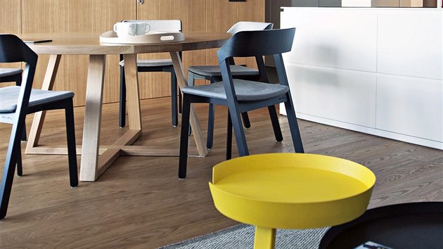 Vestavěný nábytek zde doplňuje několik designových solitérů tvořících barevný akcent, například odkládací stolky Around nebo lampa Unfold od dánského výrobce Muuto.