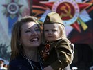 Woman and girl dressed in historical Red Army uniform wait before watching...
