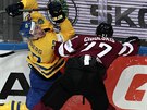 Lotyský hokejista Oskars Cibulskis (vpravo) a atakuje  Martina Lundberga z...