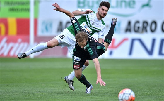 Michal Trávník z Jablonce a Josef Divíek z Píbrami (padající) bojují o balón.