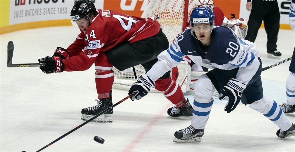 Finský hokejista Sebastian Aho (s �íslem 20) bojuje o puk s Kana�anem Morganem...
