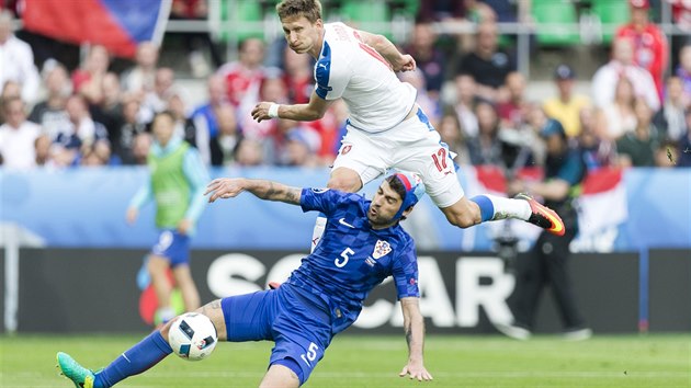 SP̊N NHRADNK. Milan koda zavelel k obratu, kdy hlavou snil na 1:2. esk tm pak v zvru vyrovnal. Na snmku bojuje s chorvatskm obrncem Vedranem orlukou, kter kvli zrann na hlav dohrval s epic.