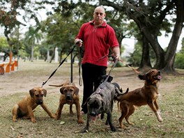 Manfred Kulitc, a 49-year-old mathematician, poses with his dogs for...