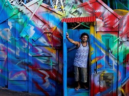 Artist Wilson Alexandre poses at the entrance of his house and art studio in...