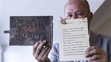 Starosta Radomil Kapar ukazuje schránku a dobový dokument z roku 1921.