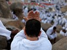 Muslim pilgrim prays on Mount Mercy on the plains of Arafat during the annual...
