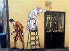 Pape Frantiek na graffiti v ímské ulici Borgo Pio vedoucí k branám Vatikánu...