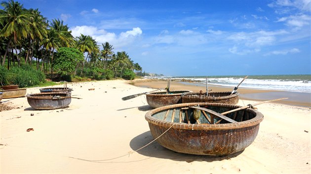 Lodě na palmové pláži v blízkosti Mui Ne