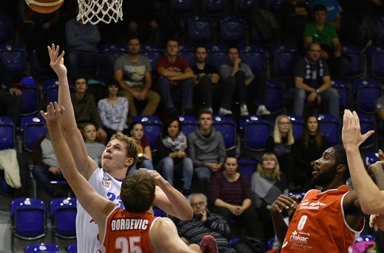 Dínský basketbalista Luká Baant (v bílém) útoí na ko Komárna.