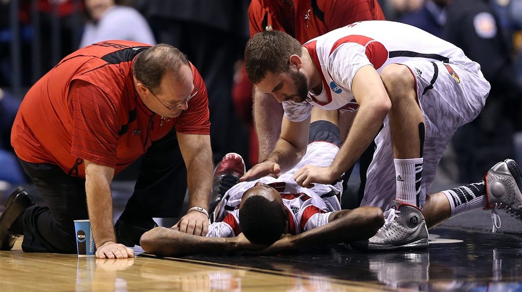 Kevin Ware z Louisville si v zápase s Duke o�kliv� zlomil nohu, ut�uje ho...