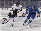 Artmij Panarin z Chicaga (vlevo) a Jay Bouwmeester ze St. Louis bojují o puk v...