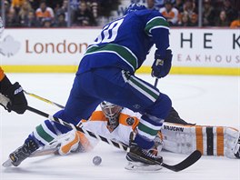 Michal Neuvirth hji branku Philadelphie ped Brendanem Gauncem z Vancouveru.