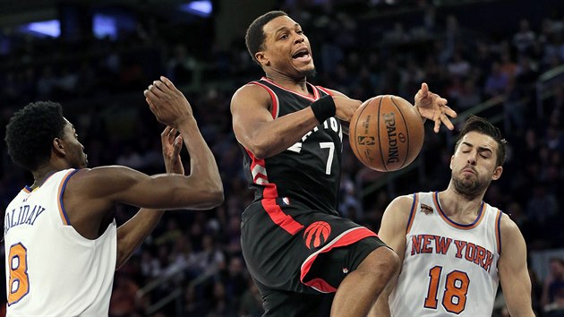 Kyle Lowry (uprosted) z Toronta ztrc m v souboji s Justinem Holidayem (vlevo) a Saou Vujaiem z New Yorku.