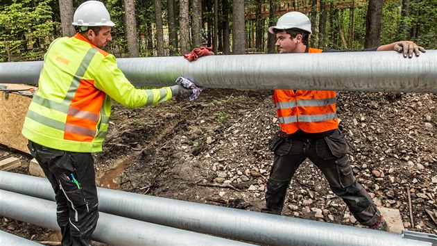 Dělníci německé firmy instalují ocelové vzpěry, které budou jistit výškový chodník na krkonošské stezce korunami stromů (16.5.2017).