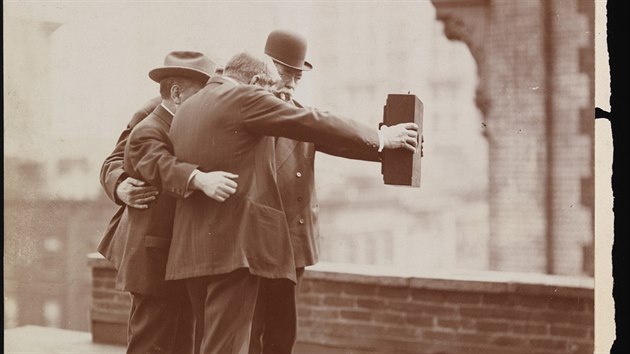 Five photographers on the roof of Colonel Marceau's photography studio prepare a group self-portrait, New York, December 1920. Among those visible are Joseph Byron, who holds one side of the camera with his right hand, and Ben Falk, who holds the other side with his left hand.