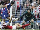 Laurent Koscielny z Arsenalu (na zemi) blokuje skluzem pokus Pedra z Chelsea,...