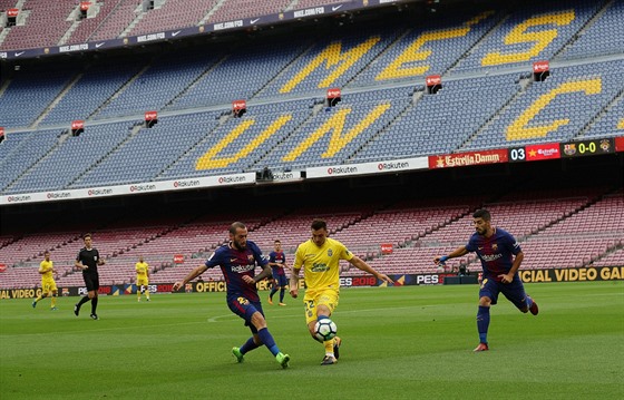 Fotbalisté Barcelony (v tmavém) a Las Palmas ped prázdnými tribunami v...