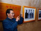 This picture taken on October 22, 2016 shows a man taking photos in a cave home...