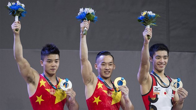 Medailisté z víceboje na gymnastickém MS: stříbrný Číňan Lin Čchao-pchan, jeho zlatý krajan Siao Žuo-tcheng a bronzový Japonec Kenzo Širai.
