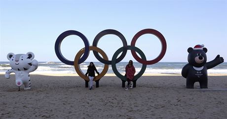 S KRUHY A MASKOTY. Na plái v Kangnungu u se lidé fotí s olympijskými symboly....