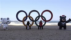 S KRUHY A MASKOTY. Na plái v Kangnungu u se lidé fotí s olympijskými symboly....