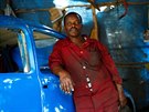 Niguse Desalegn, 45, who owns a Volkswagen Beetle garage, poses for...